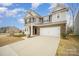 Two-story home with brick and gray siding, a two-car garage, front yard with brick column feature at 14705 Superior St, Charlotte, NC 28273