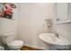 Well-lit half bath with pedestal sink and wood floors at 14705 Superior St, Charlotte, NC 28273