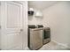 Laundry room featuring stainless steel washer and dryer with a shelf at 14705 Superior St, Charlotte, NC 28273