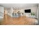 Open-concept living space with hardwood floors and a kitchen island with seating at 14705 Superior St, Charlotte, NC 28273