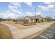 Community playground with a slide and climbing structures, located near a walking path at 14705 Superior St, Charlotte, NC 28273