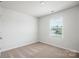 Neutral bedroom with carpeted floor and a window overlooking the backyard at 1568 Doran Ter, Richburg, SC 29729