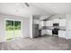 Open-concept kitchen showcasing stainless steel appliances, white cabinets, and a view to the backyard at 1568 Doran Ter, Richburg, SC 29729