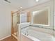 Clean and bright bathroom with tiled shower, separate tub, and frosted glass window at 15954 Harbor Hill Dr, Charlotte, NC 28273