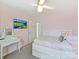 Charming bedroom with a pink wall, television, vanity, and pull out bed frame with drawers at 15954 Harbor Hill Dr, Charlotte, NC 28273