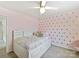 Charming bedroom with a ceiling fan, pink walls, and gold polka dots for a playful design at 15954 Harbor Hill Dr, Charlotte, NC 28273