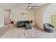 Spacious bonus room with polka dot wall and colorful rug; equipped with stylish gray sofa and ceiling fan at 15954 Harbor Hill Dr, Charlotte, NC 28273