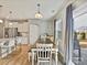 Dining area featuring a wooden table, bench seating, and a view into the kitchen and backyard at 15954 Harbor Hill Dr, Charlotte, NC 28273