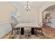 Spacious dining room with a luxurious marble table, chandelier, and large windows providing natural light at 15954 Harbor Hill Dr, Charlotte, NC 28273