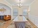 Formal dining room with statement chandelier, a decorative rug and wainscoting for an elegant touch at 15954 Harbor Hill Dr, Charlotte, NC 28273