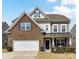 Charming two-story home with brick and vinyl siding, a well-maintained lawn, and an attached two-car garage at 15954 Harbor Hill Dr, Charlotte, NC 28273