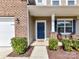 Inviting entryway with a navy blue front door, brick accents, and a cozy seating area on the porch at 15954 Harbor Hill Dr, Charlotte, NC 28273