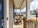 Relaxing front porch with comfortable rocking chairs, brick supports, and a view of the neighborhood at 15954 Harbor Hill Dr, Charlotte, NC 28273