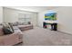 Inviting living room with a large sofa, neutral carpeting, and a mounted TV at 15954 Harbor Hill Dr, Charlotte, NC 28273