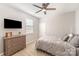 This bedroom features a ceiling fan, a dresser with a television, and natural light at 1715 Rhynes Trl, Rock Hill, SC 29732