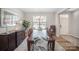 Elegant dining room with a large table, stylish chairs, and a patterned rug at 1715 Rhynes Trl, Rock Hill, SC 29732