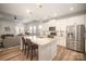 Modern kitchen featuring stainless steel appliances, a kitchen island, and open layout to the living room at 1715 Rhynes Trl, Rock Hill, SC 29732