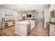 Open kitchen showcasing the island with barstool seating and a view of the adjoining living room at 1715 Rhynes Trl, Rock Hill, SC 29732