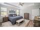 Cozy main bedroom featuring a tray ceiling, soft blue color palette, and ample natural light at 1715 Rhynes Trl, Rock Hill, SC 29732