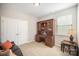 Neutral-toned office featuring a large wooden desk and hutch, plus a double door closet and a bright window at 1715 Rhynes Trl, Rock Hill, SC 29732