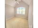 Light-filled bedroom with a large window, neutral walls, and cozy carpet flooring for a relaxing retreat at 18845 Cloverstone Cir, Cornelius, NC 28031