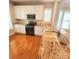 Well-lit kitchen with granite countertops, white cabinets, and stainless steel appliances at 18845 Cloverstone Cir, Cornelius, NC 28031