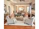 Bright living room features hardwood floors, neutral paint, and a fireplace at 18845 Cloverstone Cir, Cornelius, NC 28031