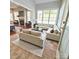 Open concept living room boasts tile flooring and lots of natural light at 18845 Cloverstone Cir, Cornelius, NC 28031