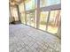 Bright sunroom featuring tile flooring, ceiling fan, and walls of windows providing ample light at 18845 Cloverstone Cir, Cornelius, NC 28031