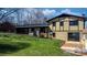 View of the backyard of a two-story home with sliding glass doors leading to a brick patio at 2530 31St Street Ne Dr, Hickory, NC 28601