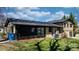 View of the backyard with a sliding glass door and air conditioning unit near a black exterior wall at 2530 31St Street Ne Dr, Hickory, NC 28601