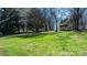 Large, grassy backyard featuring mature trees and a shed at 2530 31St Street Ne Dr, Hickory, NC 28601