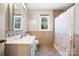 Bathroom featuring tiled flooring and walls, a shower with curtain, and a vanity with a decorative mirror at 2530 31St Street Ne Dr, Hickory, NC 28601