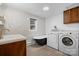 Modern bathroom with a soaking tub, a laundry, a vanity, and a window at 2530 31St Street Ne Dr, Hickory, NC 28601