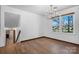 Dining room with hardwood floors, chandelier, large windows, and a doorway to a carpeted stairway at 2530 31St Street Ne Dr, Hickory, NC 28601