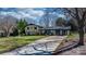 A view of the exterior of the home showing the driveway, front yard, and mature trees at 2530 31St Street Ne Dr, Hickory, NC 28601