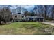 Well-manicured lawn leads to a house with mature trees and blue skies at 2530 31St Street Ne Dr, Hickory, NC 28601