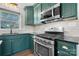 Green kitchen featuring a stainless steel stove and microwave, and granite countertops at 2530 31St Street Ne Dr, Hickory, NC 28601