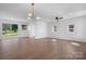 Bright living room featuring wood floors, a modern light fixture, and sliding glass doors to the backyard at 2530 31St Street Ne Dr, Hickory, NC 28601