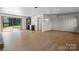 Open floor plan living room with hardwood floors, large glass doors, and a built-in wet bar at 2530 31St Street Ne Dr, Hickory, NC 28601