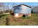 Exterior back of the home features vinyl siding, brick foundation and a wooden deck at 2725 Fair Oaks Dr, Gastonia, NC 28054