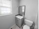 Small bathroom includes vanity with mirror, toilet, and window for natural light at 2725 Fair Oaks Dr, Gastonia, NC 28054