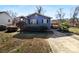 Charming blue home featuring a landscaped front yard, sidewalk and a wooden deck on the side at 2725 Fair Oaks Dr, Gastonia, NC 28054