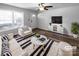 Bright living room featuring hardwood floors, a ceiling fan, and natural light from the front door at 2725 Fair Oaks Dr, Gastonia, NC 28054