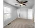 This bedroom features a ceiling fan, neutral carpeting, and access to an ensuite bathroom at 2725 Fair Oaks Dr, Gastonia, NC 28054