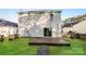 Backyard featuring a wooden deck, grassy area, and partial fence, creating a welcoming outdoor space at 2868 Oasis Ln, Charlotte, NC 28214