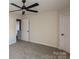 A well-lit bedroom features neutral carpet, a ceiling fan and two closets for ample storage space at 2868 Oasis Ln, Charlotte, NC 28214