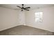 Bedroom features a ceiling fan, carpet, and large window at 2868 Oasis Ln, Charlotte, NC 28214