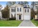 Two-story home with neutral siding, dark shutters, and well-manicured lawn, showcasing curb appeal and charm at 2868 Oasis Ln, Charlotte, NC 28214