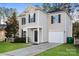 Charming two-story home with a well-manicured lawn, complemented by black shutters and a classic garage at 2868 Oasis Ln, Charlotte, NC 28214